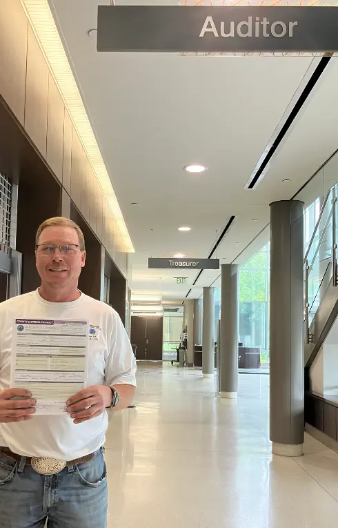 Jon Dorau holding his candidate filing paperwork outside the Pine County Auditor's office
